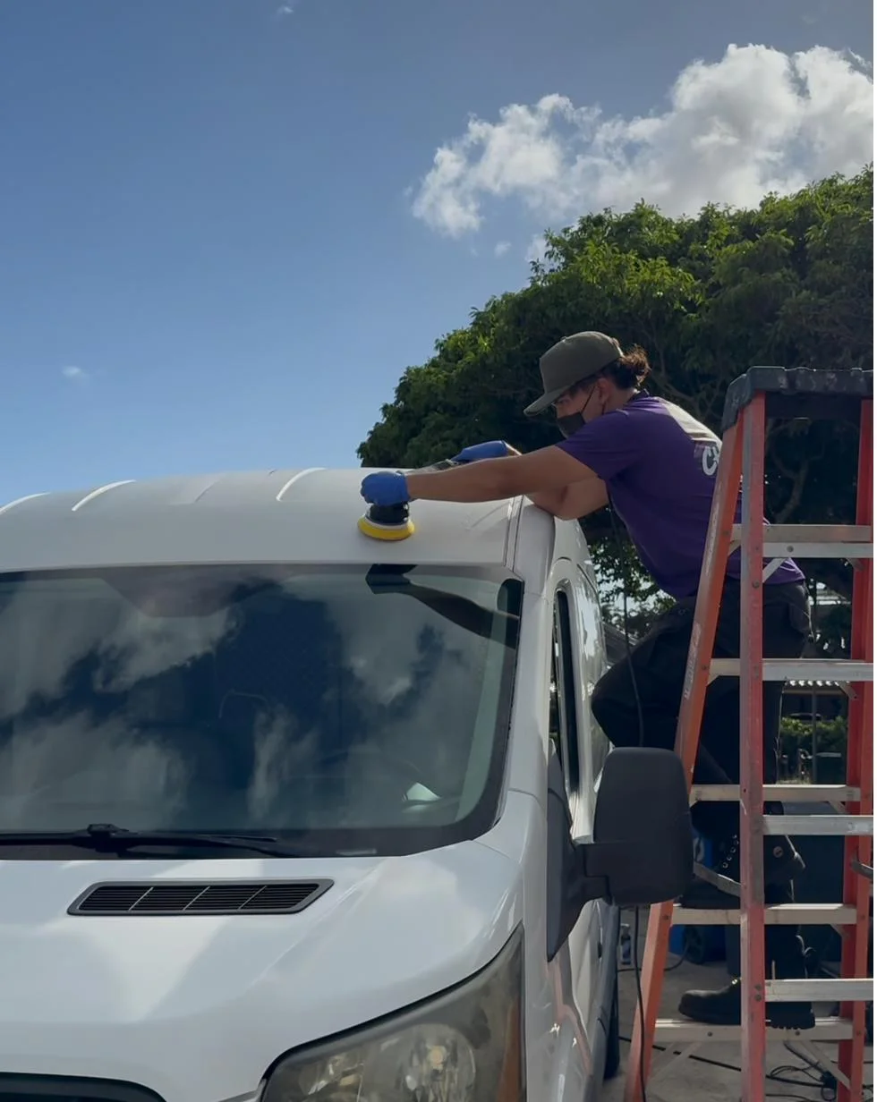 Chopped Details technician machine-polishing a van roof from a ladder in Honolulu