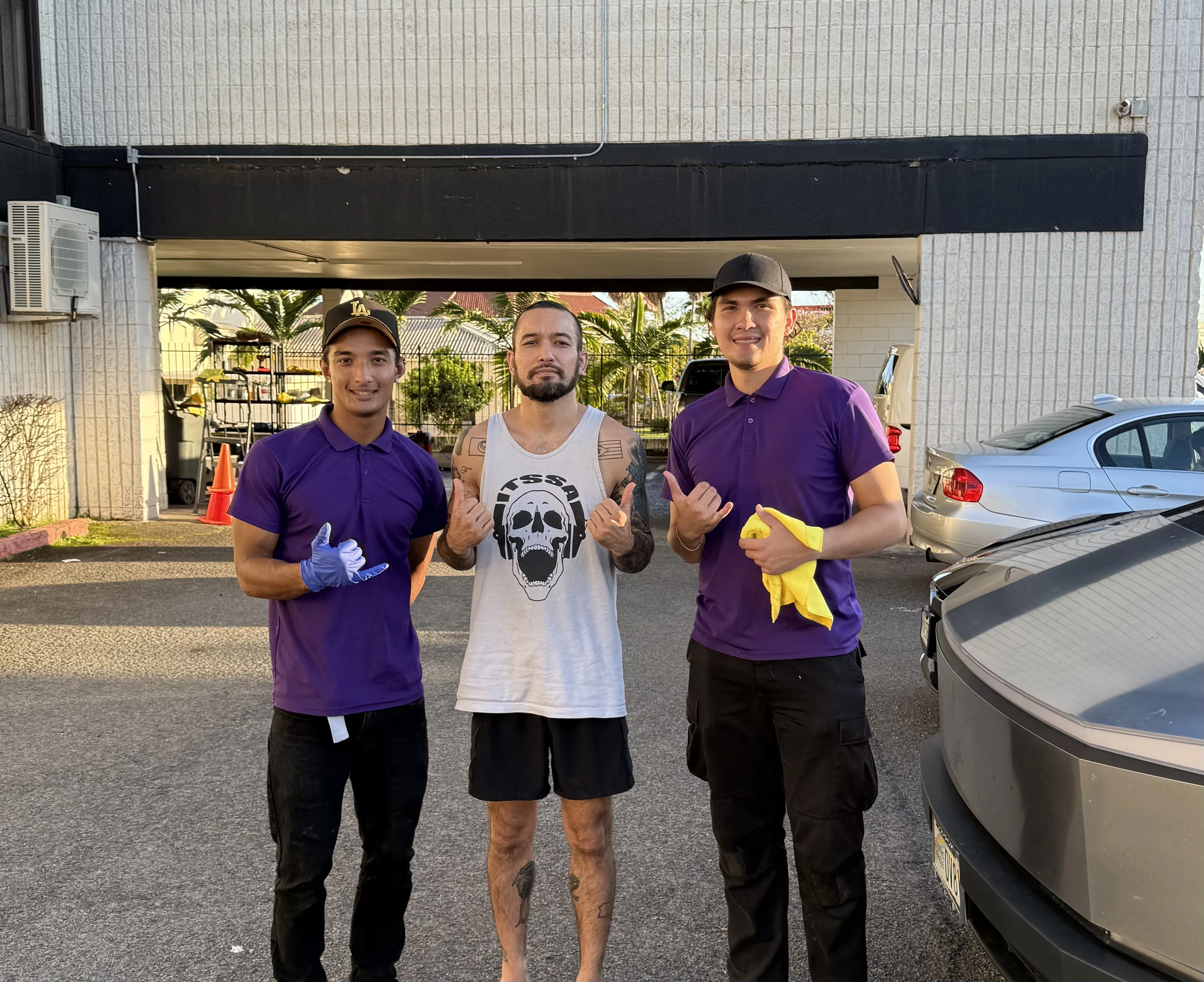 Brandon Flores and Jai Mortensen, co-owners of Chopped Details, with a customer after a detail